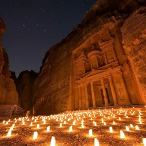 A nighttime view of Petra showing the Siq pathway illuminated by hundreds of glowing candles, leading to the Al-Khazneh façade carved into the rose-red rock, shimmering under the moonlight in a serene and magical atmosphere.