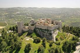 Alt Text: "A scenic view of the historical Ajloun Castle, with lush greenery and mountains surrounding it, showcasing the beauty of the area during a Ramadan Iftar trip."